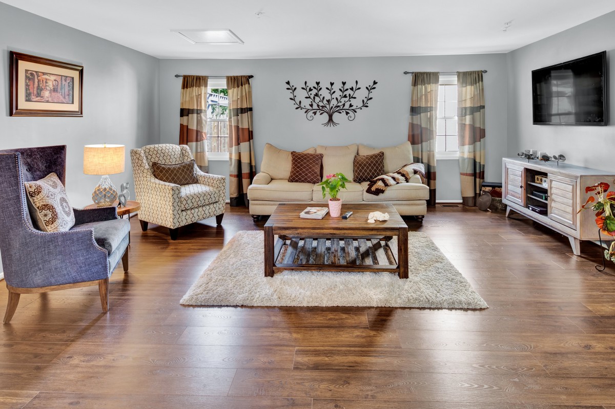 A cozy living room with a comfortable couch, armchairs, a wooden coffee table, and stylish decor.