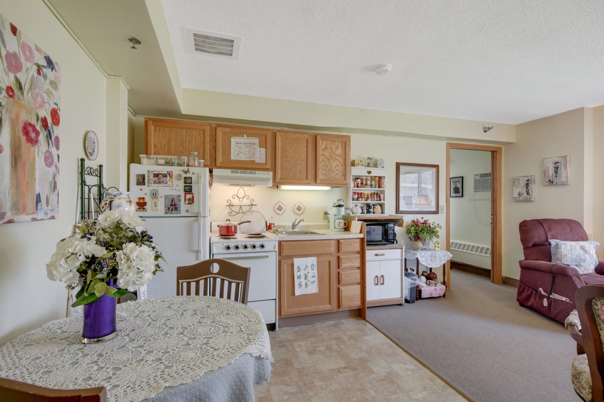 Cozy apartment kitchen with dining area.