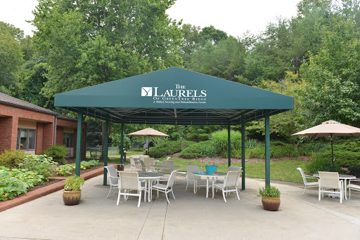 A serene outdoor pavilion with seating, surrounded by lush greenery.