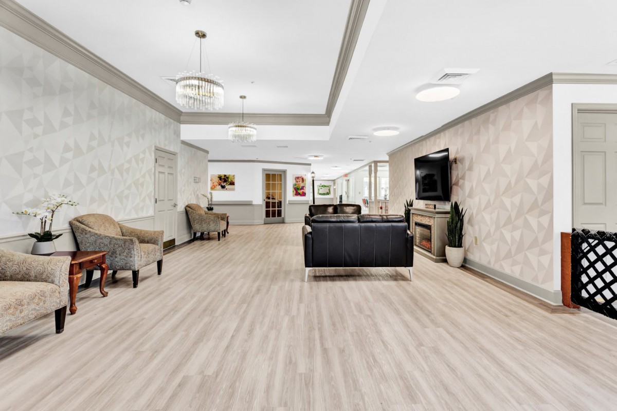 A modern lobby with seating area and television.