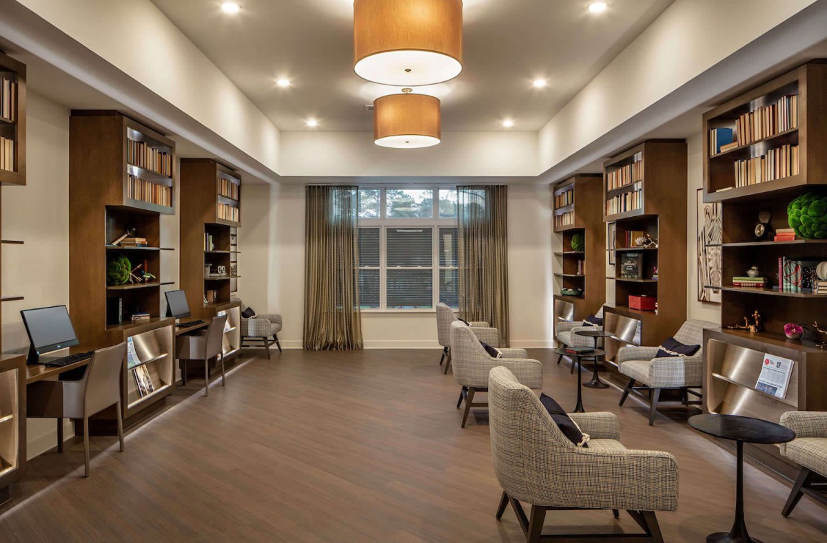 A cozy library reading room with bookshelves and comfortable seating.