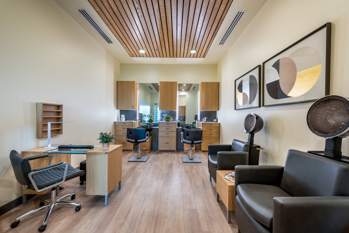 Modern hair salon interior with stylish furniture and artwork.