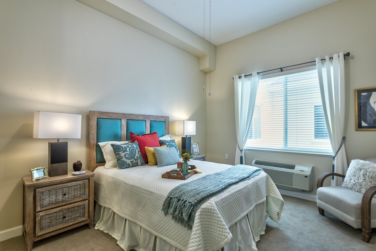 A cozy and well-decorated bedroom with a neatly made bed and soft lighting.
