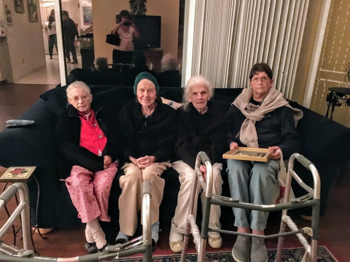 A group of elderly individuals seated together indoors.