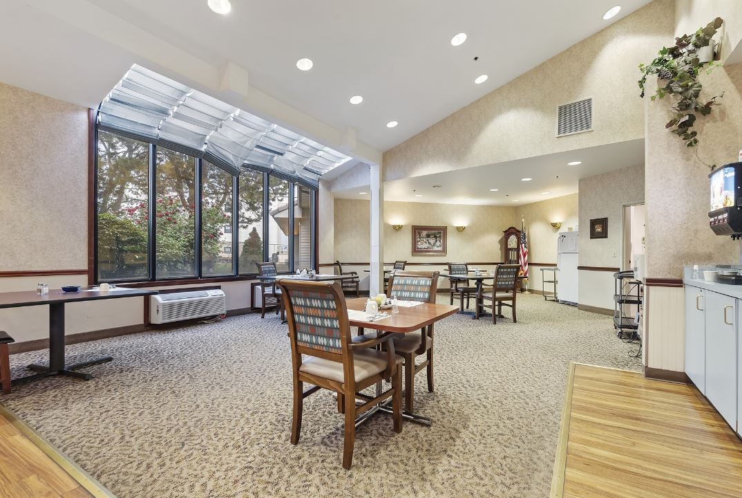 A bright and spacious dining area with large windows allowing natural light to fill the room.