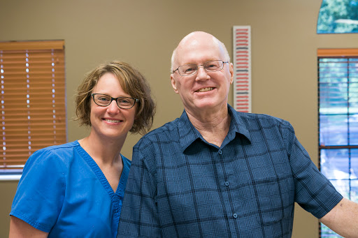 A cheerful moment shared between two individuals in a healthcare setting.
