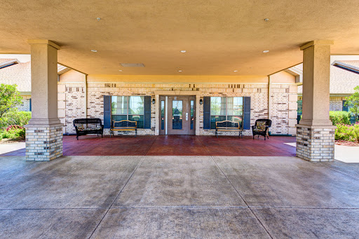 Entrance area of a building featuring seating and large windows.