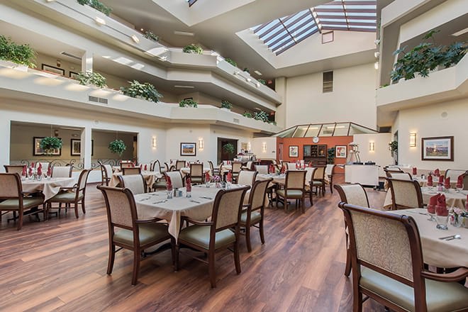 Spacious dining area with elegant furnishings and natural lighting.