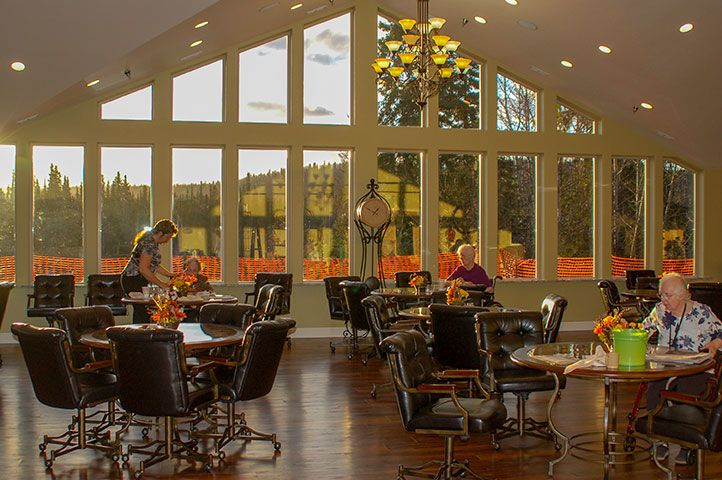 A cozy restaurant interior with large windows providing ample natural light.