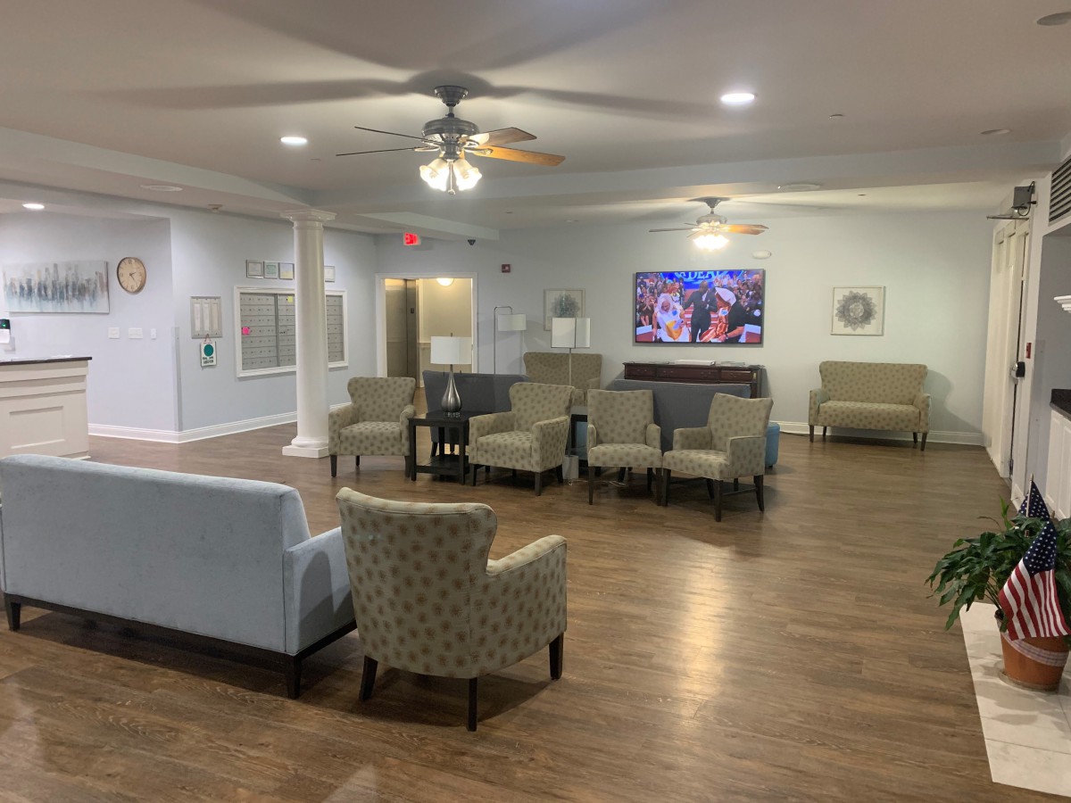 A spacious living room with comfortable seating and a large television.