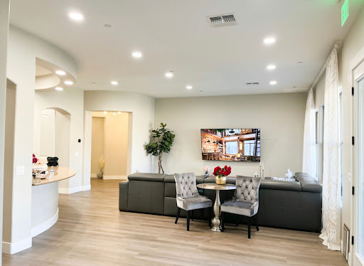 A modern living room featuring sleek furniture and a cozy dining area.