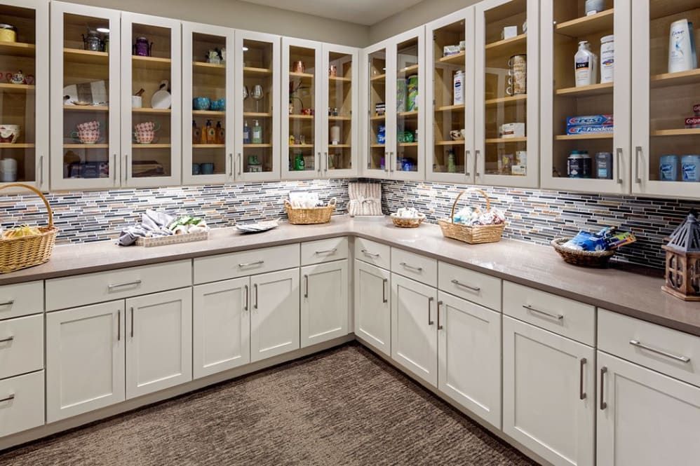 A well-organized kitchen with white cabinets and ample storage space.