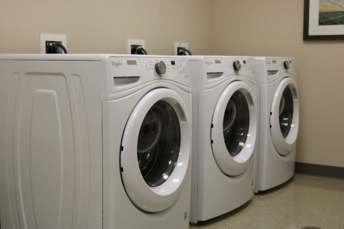 A row of modern washing machines in a laundromat.