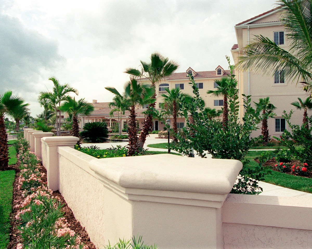 A well-maintained residential area featuring lush palm trees and modern architecture.