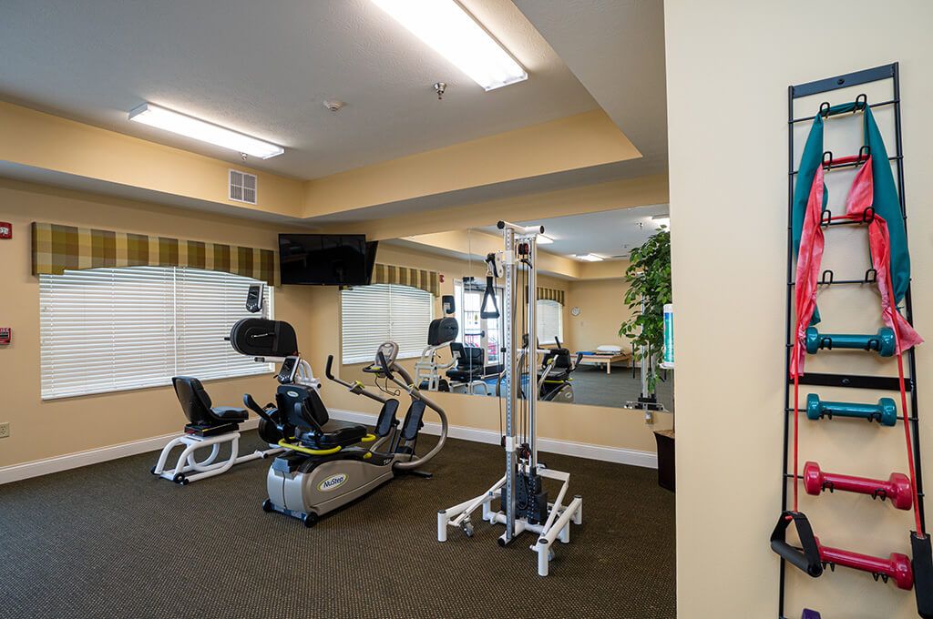 A well-equipped indoor gym with various exercise machines.