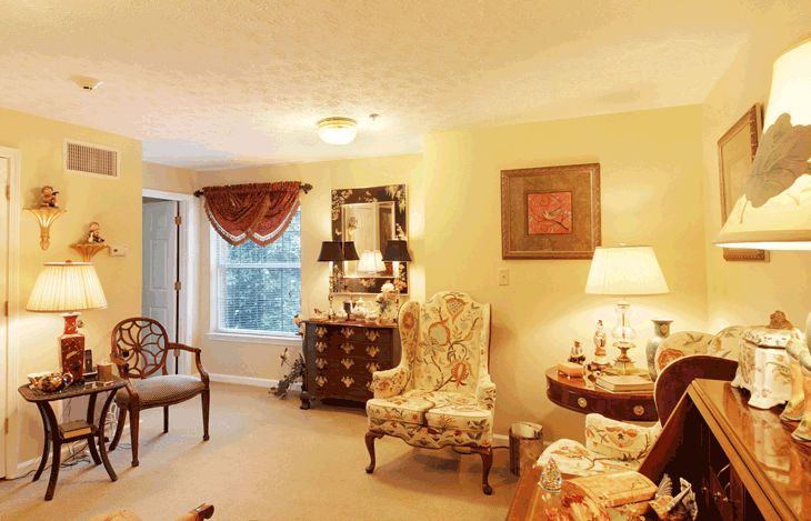 A cozy vintage-style living room with elegant furniture and warm lighting.