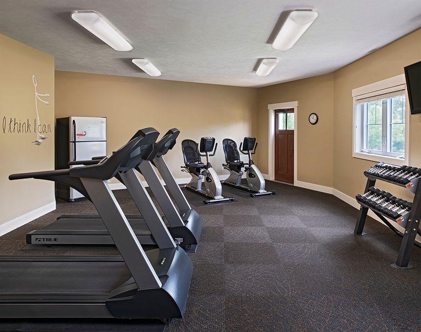 A well-equipped gym with treadmills and exercise bikes.