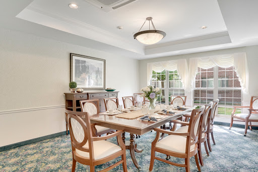 A well-appointed dining room featuring elegant furniture and soft natural light.