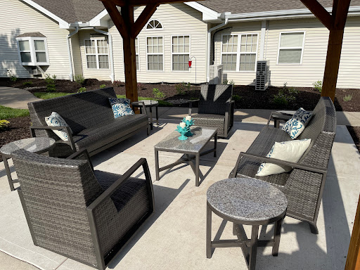 A cozy outdoor seating area featuring modern wicker furniture and a stylish coffee table.