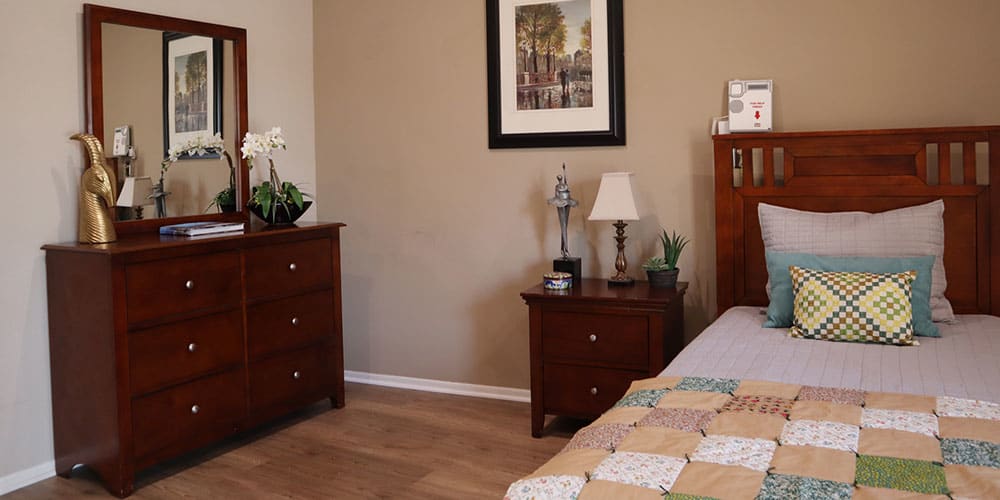 A cozy bedroom with wooden furniture and decorative items.