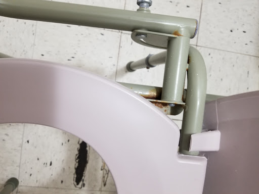 Close-up view of plumbing components showing rust and wear.