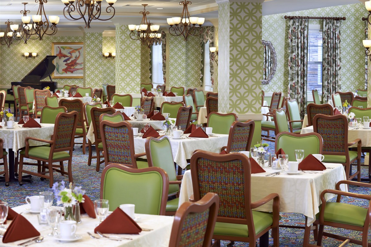 An elegant dining area with neatly arranged tables and chairs, featuring a classic interior design.