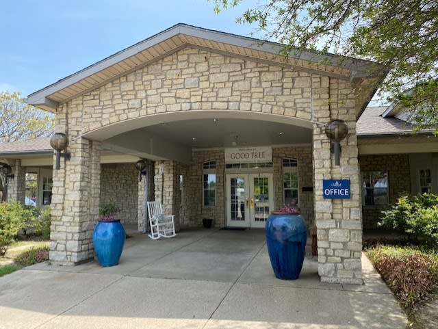 Entrance to a building with stone architecture and large blue pots.