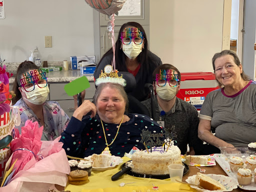 A joyful birthday celebration with family and friends, featuring a delicious cake and festive decorations.