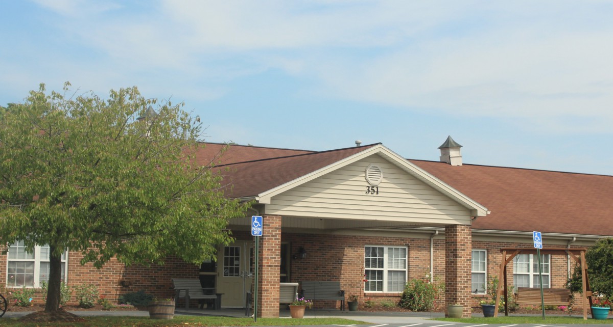 A suburban residential house with a brick exterior and a front porch.