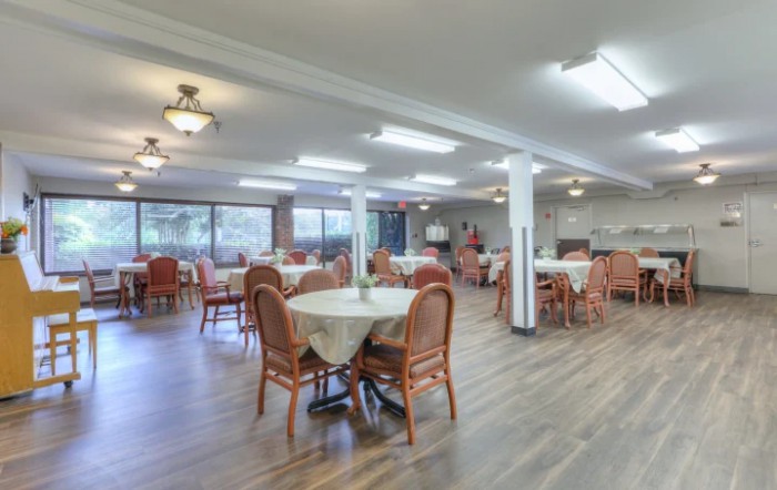 An indoor dining area with numerous tables and chairs arranged neatly.