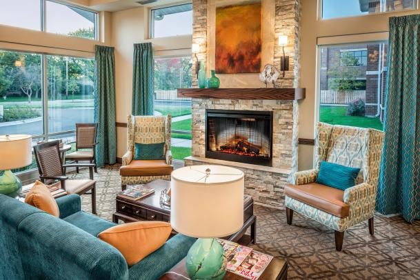 A cozy living room with comfortable furniture and a warm fireplace.
