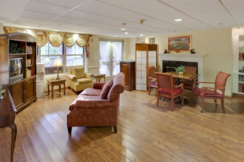A cozy living room with comfortable seating and a fireplace.