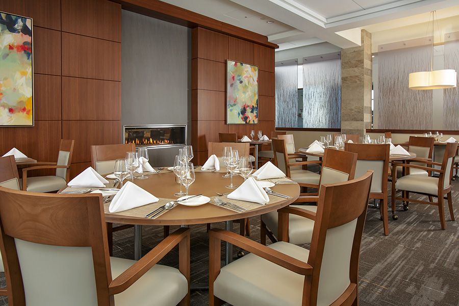 An elegant restaurant interior with a neatly set dining table.