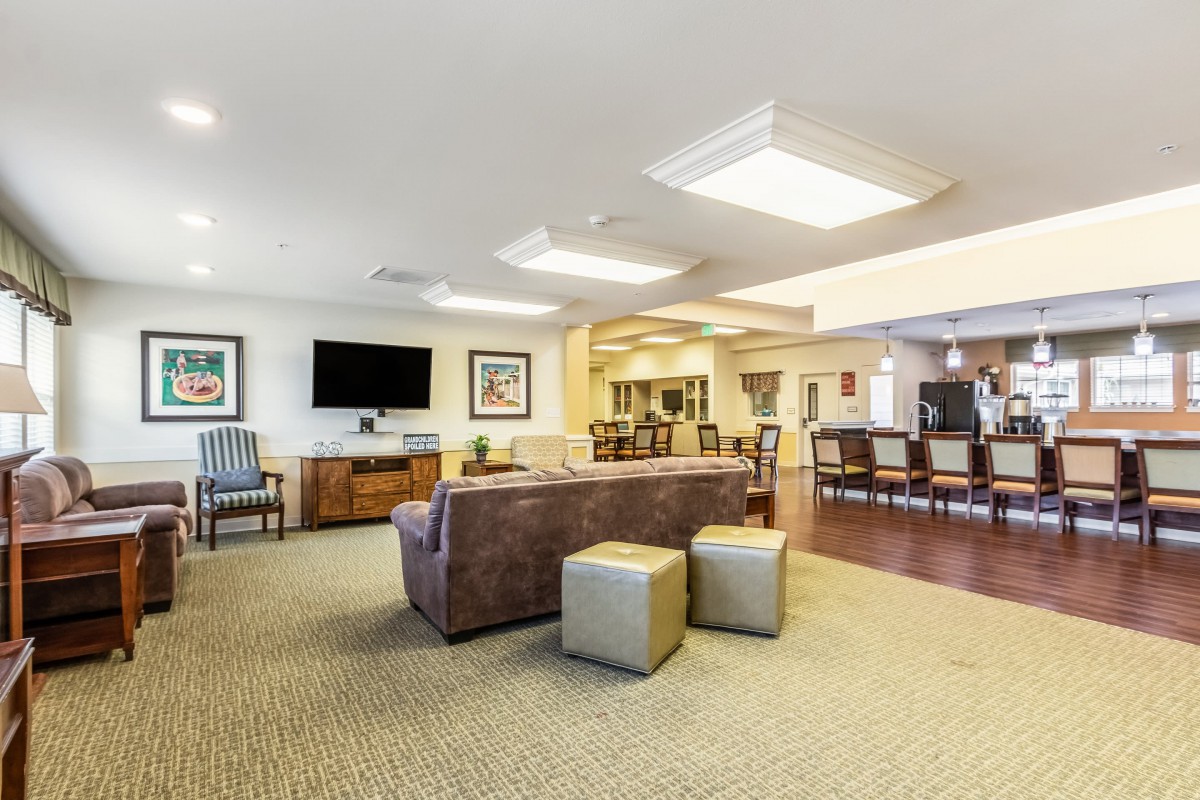 A spacious and modern living room with a comfortable seating area, television, and stylish furnishings.