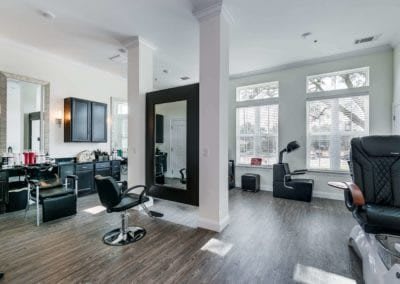 Modern hair salon interior with sleek design and ample natural light.