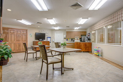 Cozy dining and communal area with modern furniture and a kitchenette.