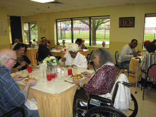Seniors enjoying a meal together in a communal dining area.