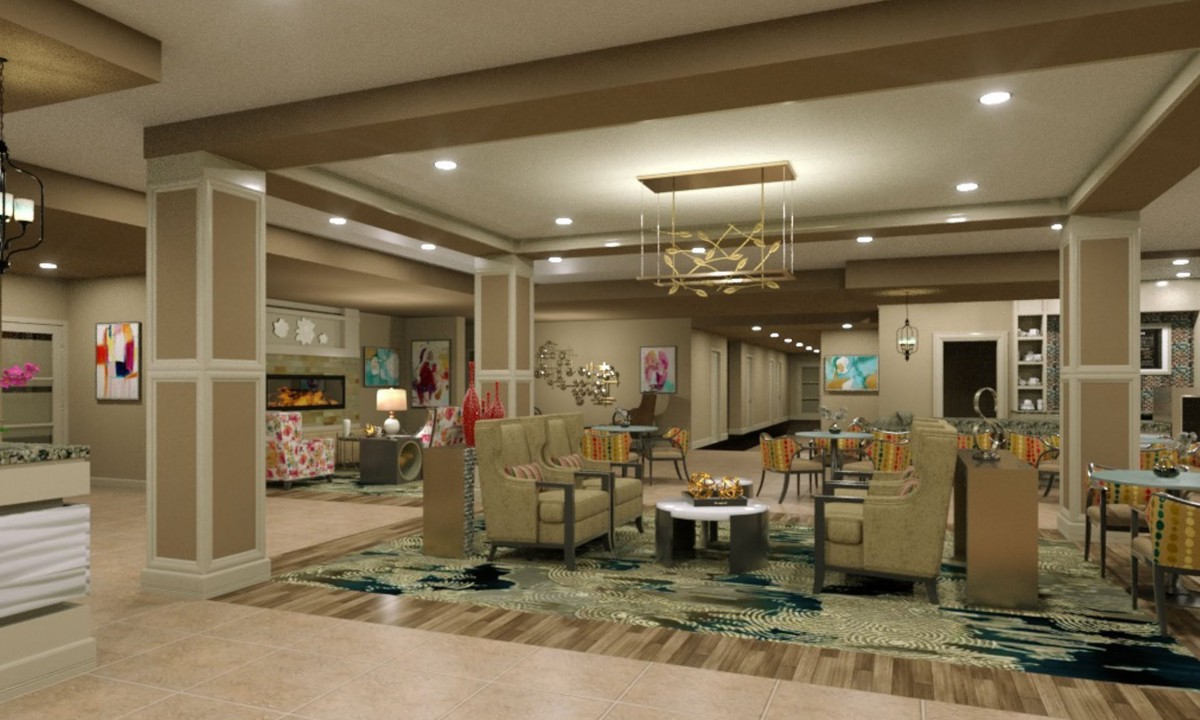 A modern lounge area featuring comfortable seating, a stylish chandelier, and elegant decor.
