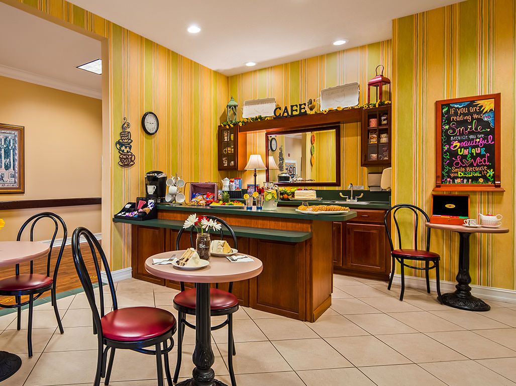 A cozy cafe interior with a breakfast setup and seating area.