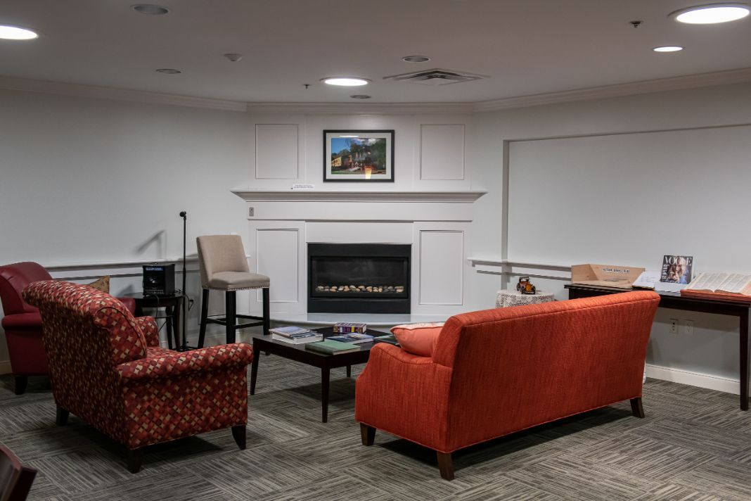 A cozy living room with a fireplace and comfortable seating.