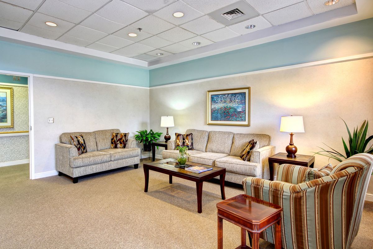 A cozy waiting room with comfortable seating and soft lighting.