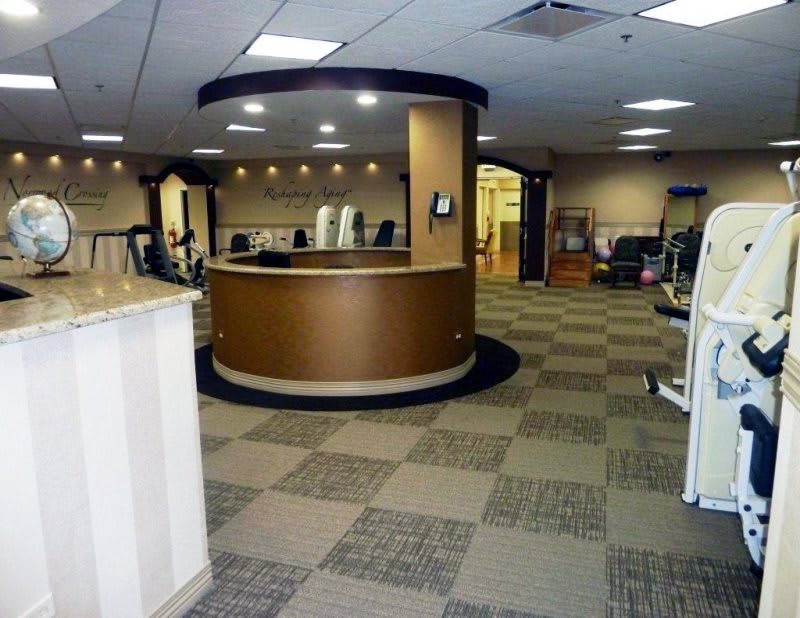 A modern office reception area with a round desk and checkered flooring.