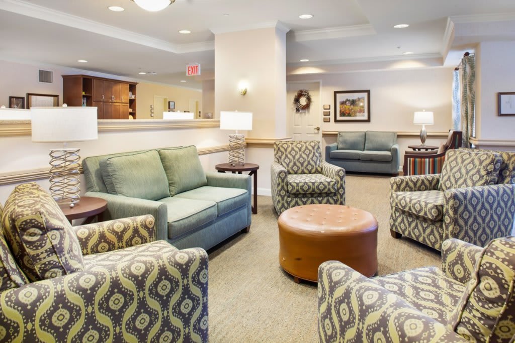 A cozy waiting area with comfortable seating arrangements, including sofas and armchairs.