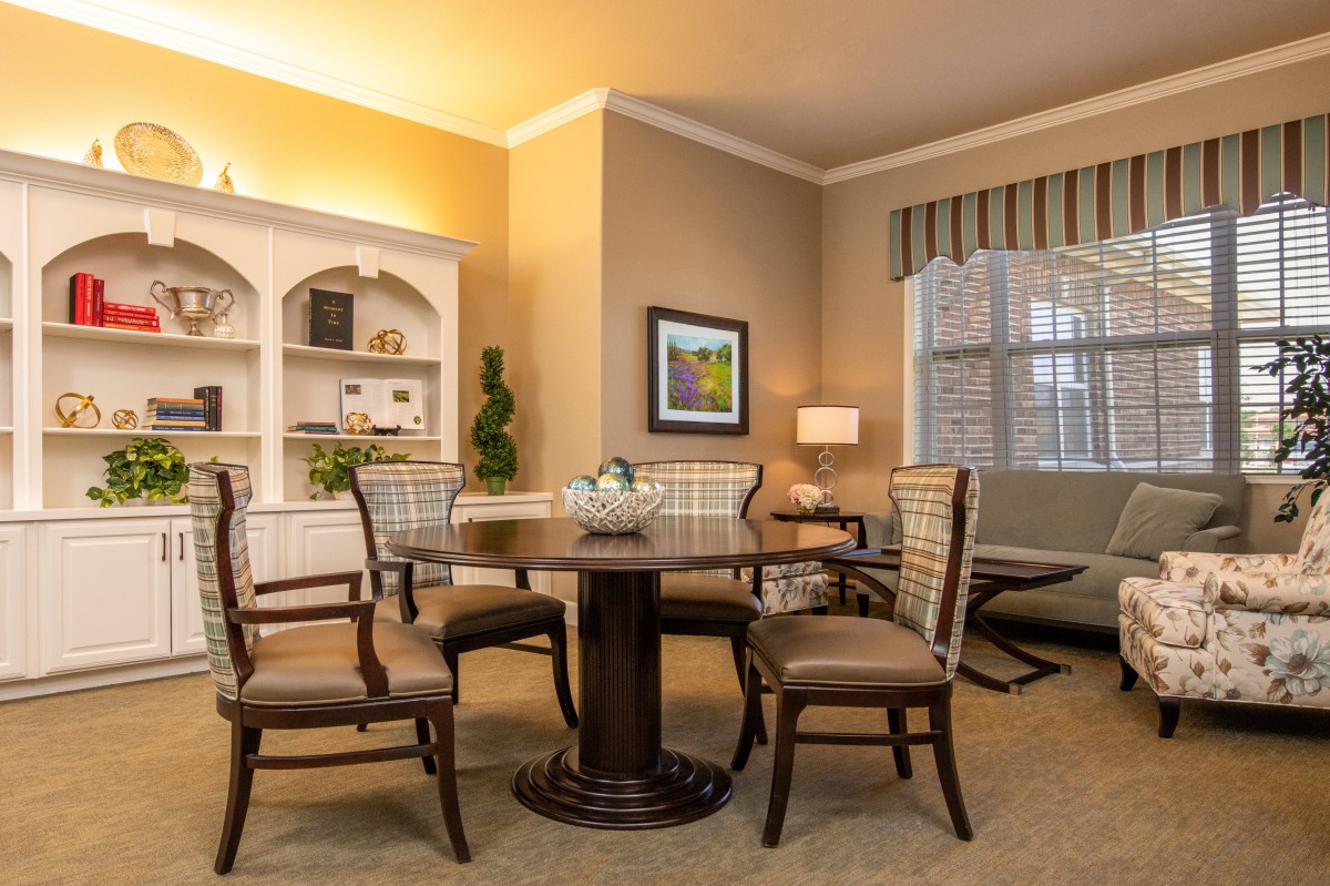 A cozy dining room with elegant furniture and soft lighting.