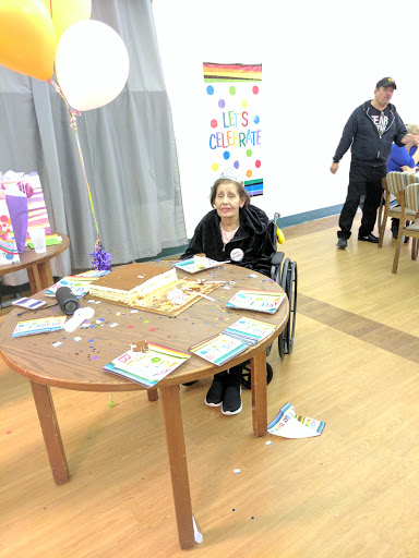 A child in a wheelchair enjoying an event at a community space.