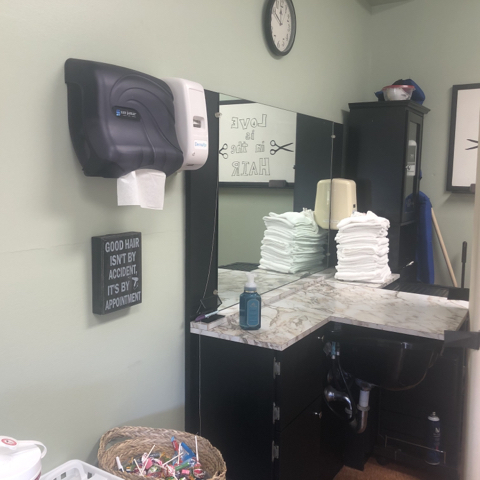 A tidy bathroom space featuring stacked towels and essential amenities.