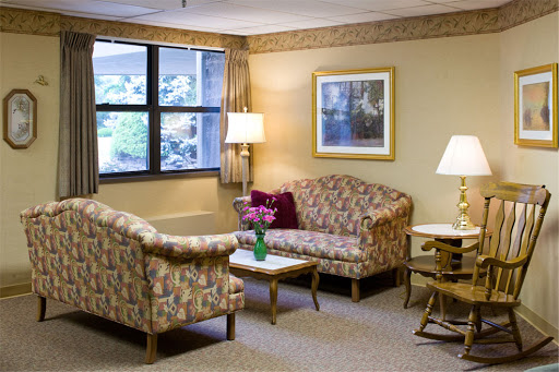 A cozy living room setup featuring patterned sofas, a coffee table, and warm lighting.