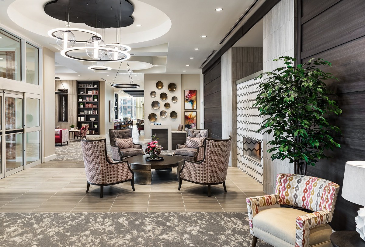 A modern lobby featuring elegant seating with stylish decor and bright lighting.