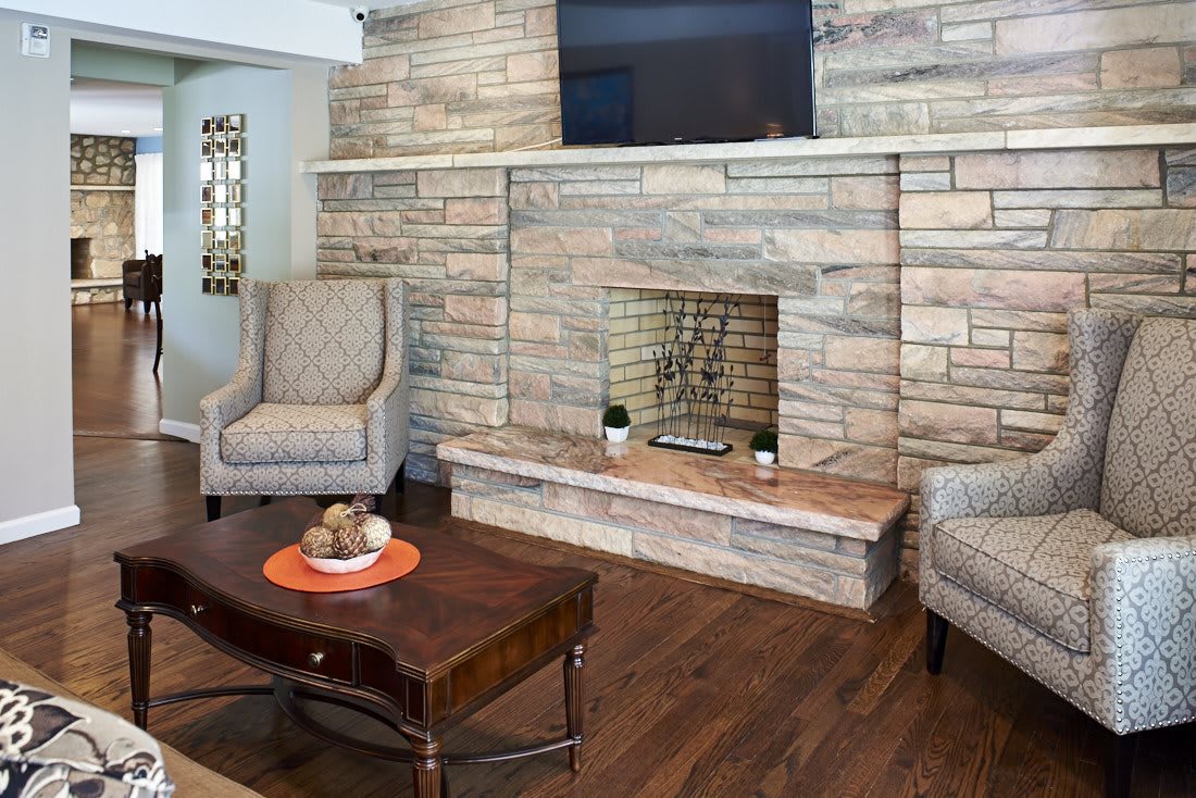 Cozy living room with a stone fireplace and elegant seating.