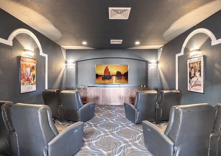 A luxurious home theater with comfortable seating and a large screen for an immersive movie experience.